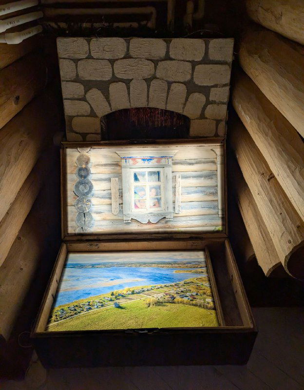 Экспонат в музее нацпарка: иллюстрированная шкатулка с пейзажами Кенозерья и народными рисунками на деревянной основе