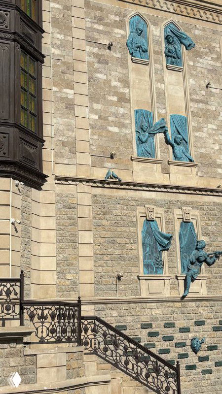 Деталь фасада с барельефами на здании в Баку, украшения и архитектурные элементы вблизи, текстура камня и декоративные элементы