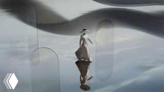 Кадр из ролика для Lotte mall West Lake Hanoi: стилизованный персонаж на зеркальной поверхности в абстрактном оформлении.