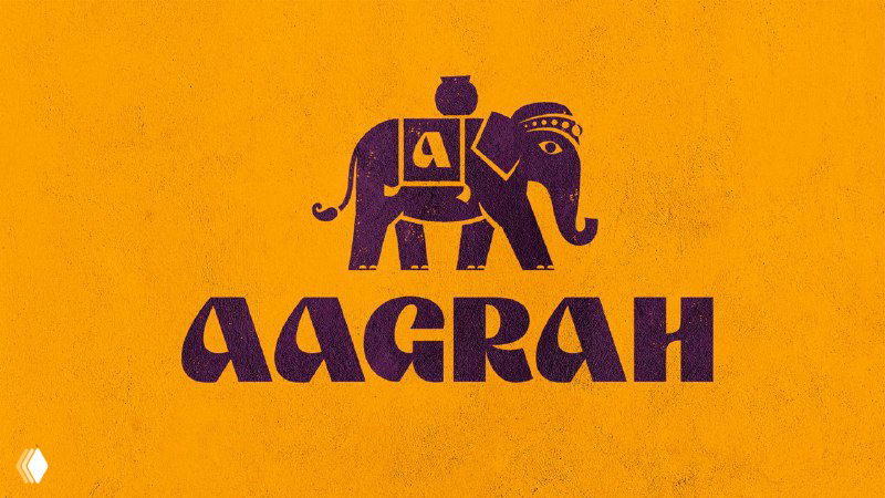 Логотип Aagrah на ярко-оранжевом фоне: стилизованный слон и название бренда в тёмно-фиолетовом тоне, фактура бумаги.