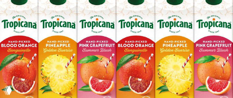 Ряд картонных пачек разных вкусов Tropicana в новой графике: яркие изображения фруктов и единый фирменный стиль упаковки.