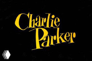 Жёлтая декоративная леттеринговая надпись «Charlie Parker» на тёмном фоне — образец оригинальной типографики для джазовых афиш.