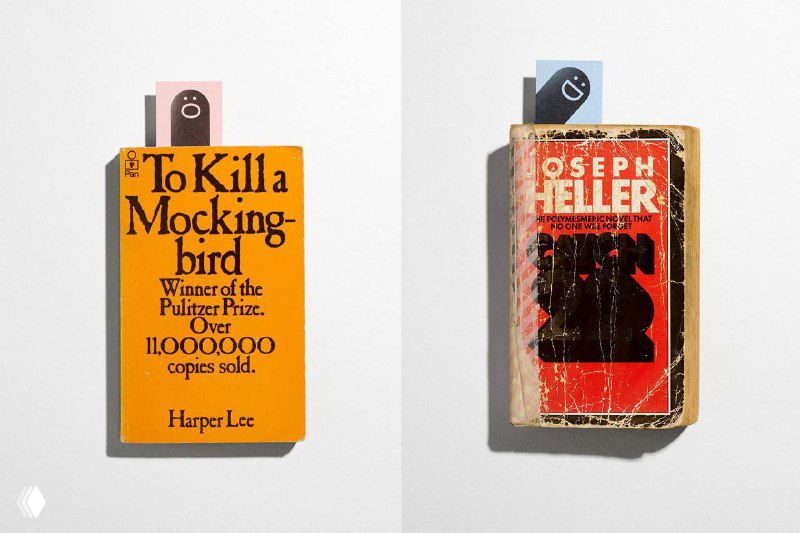 Две подержанные книги с фирменными закладками Hungry Worms: иллюстрации червей функционируют как указатели жанров и элементы пользовательского опыта в библиотеке.