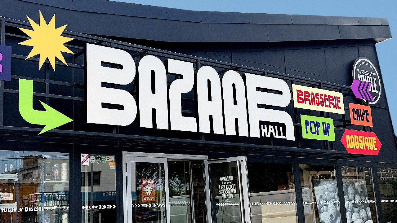Крупный план оформленной вывески «BAZAAR HALL» с цветными указателями и стикерами, демонстрация масштабов и фактуры букв.
