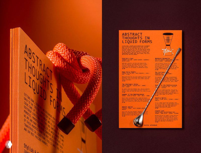Разворот печатной продукции Gaya Athens: оранжевые листовки и книга с крупным шрифтом, меню и графические элементы демонстрируют типографику и структуру материалов.
