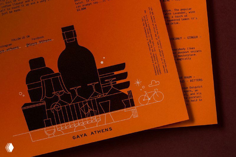 Крупный план печатной продукции: чёрная иллюстрация бутылок, графика и подпись GAYA ATHENS на ярко-оранжевой бумаге, акцент на графическом мотиве и качестве печати.