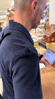 Сотрудник или покупатель использует планшет в магазине: кадр демонстрирует процессы обслуживания и технологию работы с клиентом.