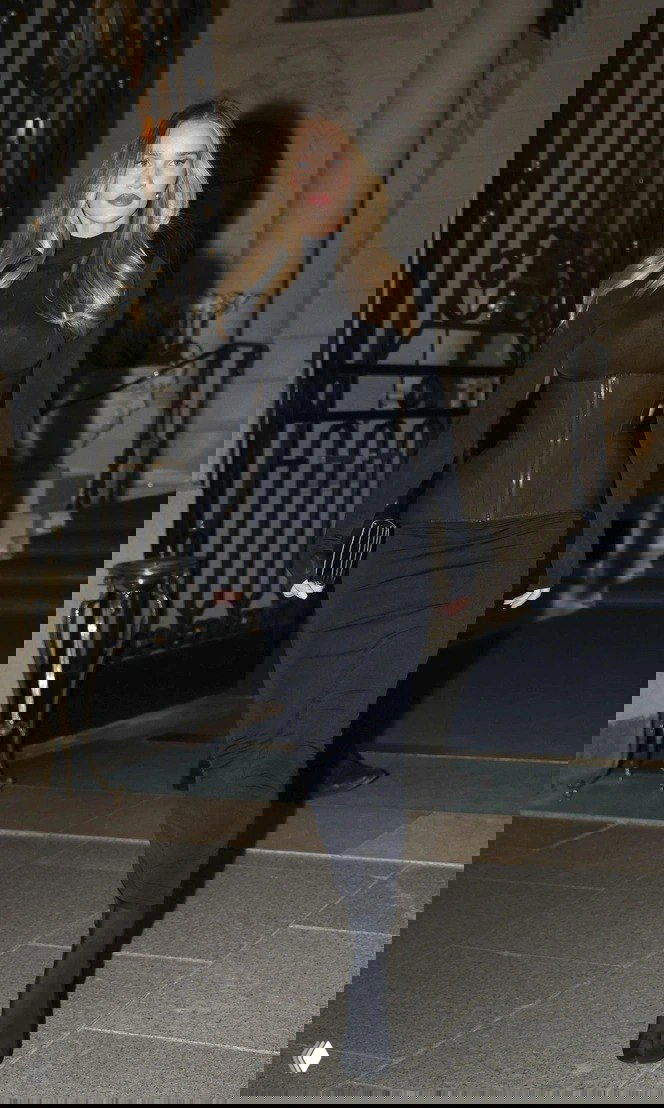 Модель в чёрном облегающем образе и плотном корсете, подчёркивающем талию — пример приёма «затянуться потуже» для элегантности