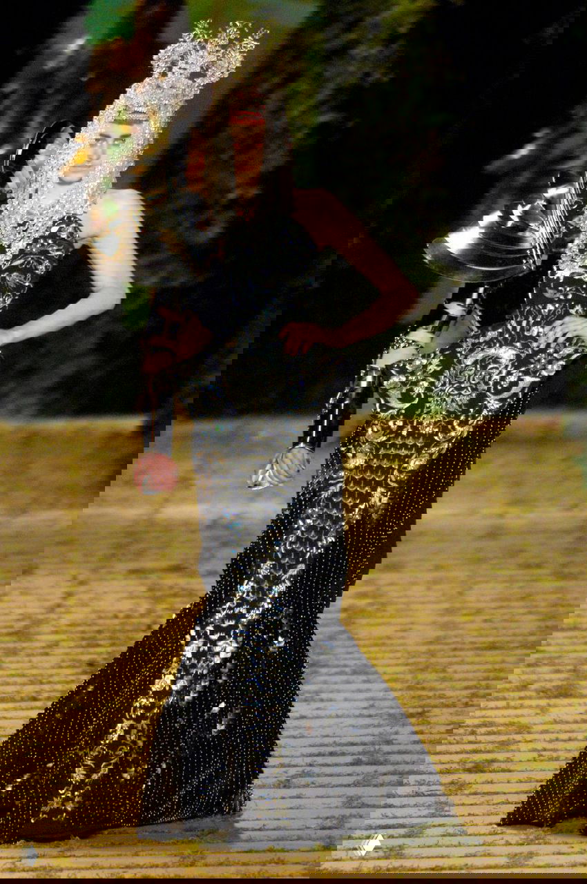 Модель в черном кутюрном платье Dior 2006 с серебристыми декоративными элементами и металлической наплечной деталью, драматичный образ на показе.