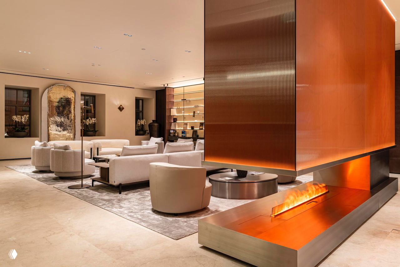 Гостиная зона резиденции MR Private: светлая мягкая мебель, низкий камин и крупные деревянные панели в тёплых оттенках.