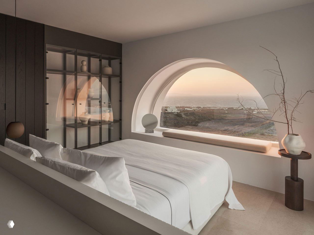 Спальня с характерным арочным окном: белые текстили, минималистичная мебель и панорамный вид на побережье через полукруглое окно.
