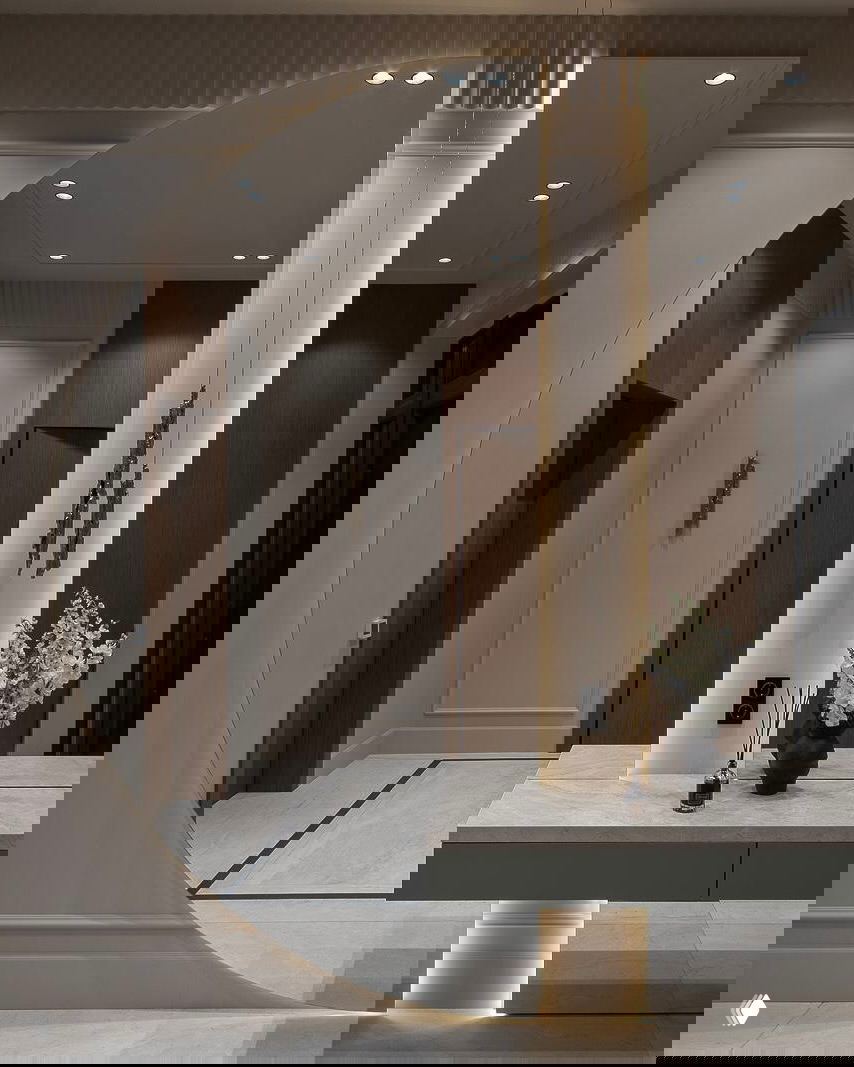 Архитектурный интерьер прихожей: круговое зеркало, консоль на колонне и тонкая подсветка создают эффект глубины и пространства.