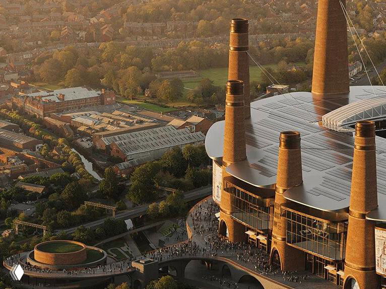 Аэрофотография стадиона с кирпичными башнями и округлыми кровлями, встроенная в городской пейзаж и зелёные окрестности.