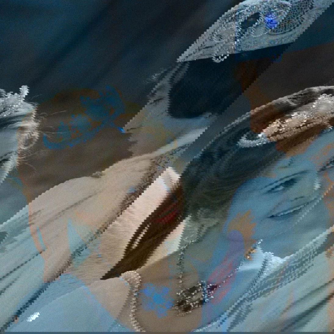 Кадр из «Три орешка для Золушки»: молодая героиня в короне и украшениях смотрит на принца на фоне зимнего пейзажа.