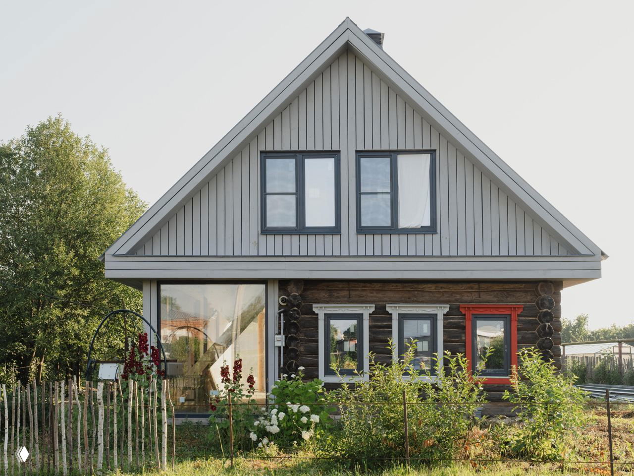 Фасад гостевого дома «Липа» в Менчакове: сохранённый бревенчатый сруб сочетается со стеклянными объёмами и садовым ландшафтом.