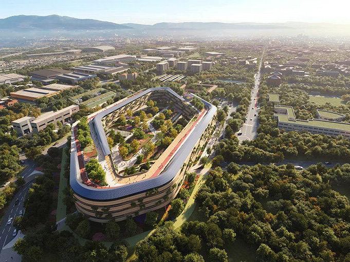 Аэровид визуализации проекта больницы Мальпенса от Zaha Hadid Architects: овальный корпус с зелёной кровлей, открытыми ландшафтами и окружающей зеленью.