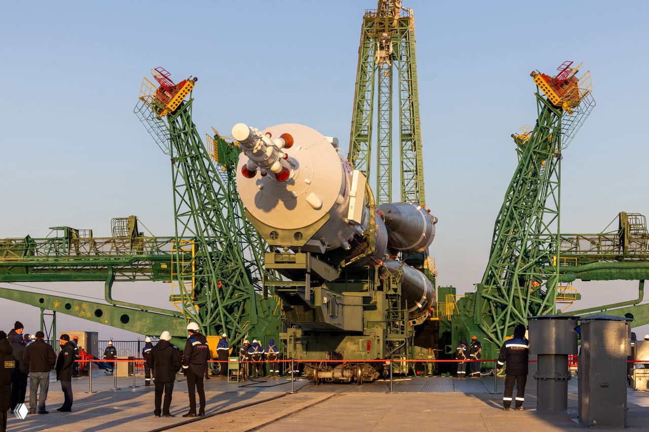 Крупный план носовой части корабля «Союз» и сопутствующей пусковой конструкции во время установки на стартовый стол на Байконуре.