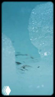 Крупный план льда и ледяных кристаллов на голубом фоне — фрагмент видео о леднике в районе Безенгийской стены, подчёркивающий ледниковую природу региона.