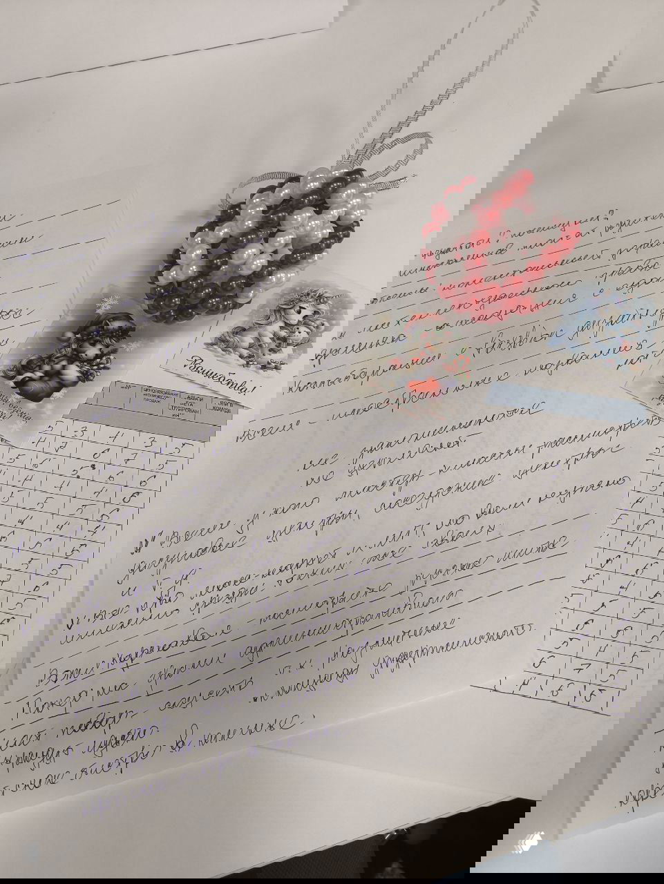 Блокнот с заметками и таблица оценок, рукописные пометки экспертов и небольшие праздничные сувениры на столе.