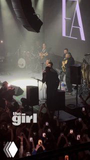 Вид сцены с высоты: Эмре Алтуг, музыканты и саксофонист во время «Bu Kadar Mi», публика держит телефоны и фонарики