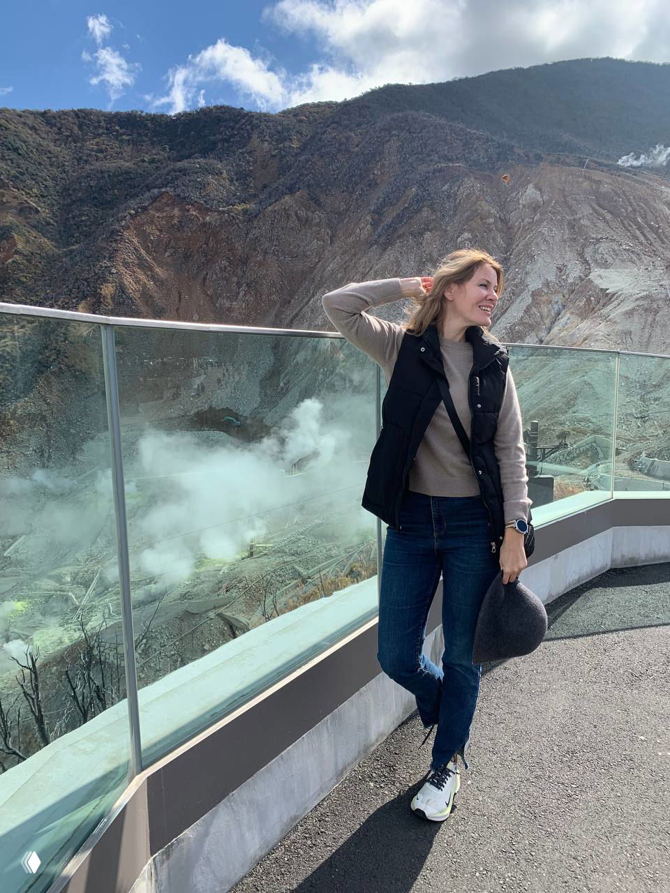 Автор поста на смотровой площадке над кратером: человек стоит у стеклянного ограждения, внизу виден пар, скалы и вулканический рельеф Хаконэ.