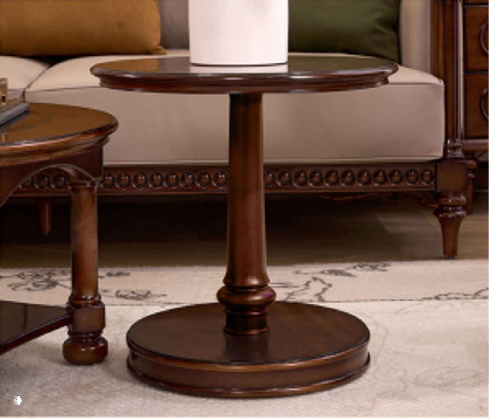 Крупный план круглого журнального столика из тёмного дуба в интерьере: центральная ножка‑пьедестал и круглая база на ковре рядом с диваном.