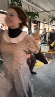 Динамичный кадр танцовщицы в движении внутри трамвая — размытый портрет, передающий энергию и праздничный драйв сценического номера.