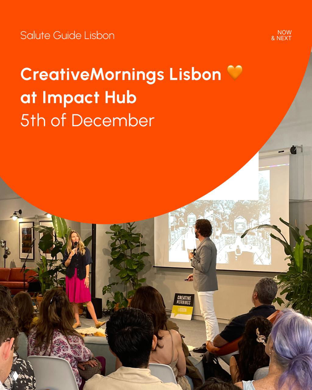 CreativeMornings Lisbon event at Impact Hub: a speaker on stage and an audience seated in a bright room with plants and a presentation screen.